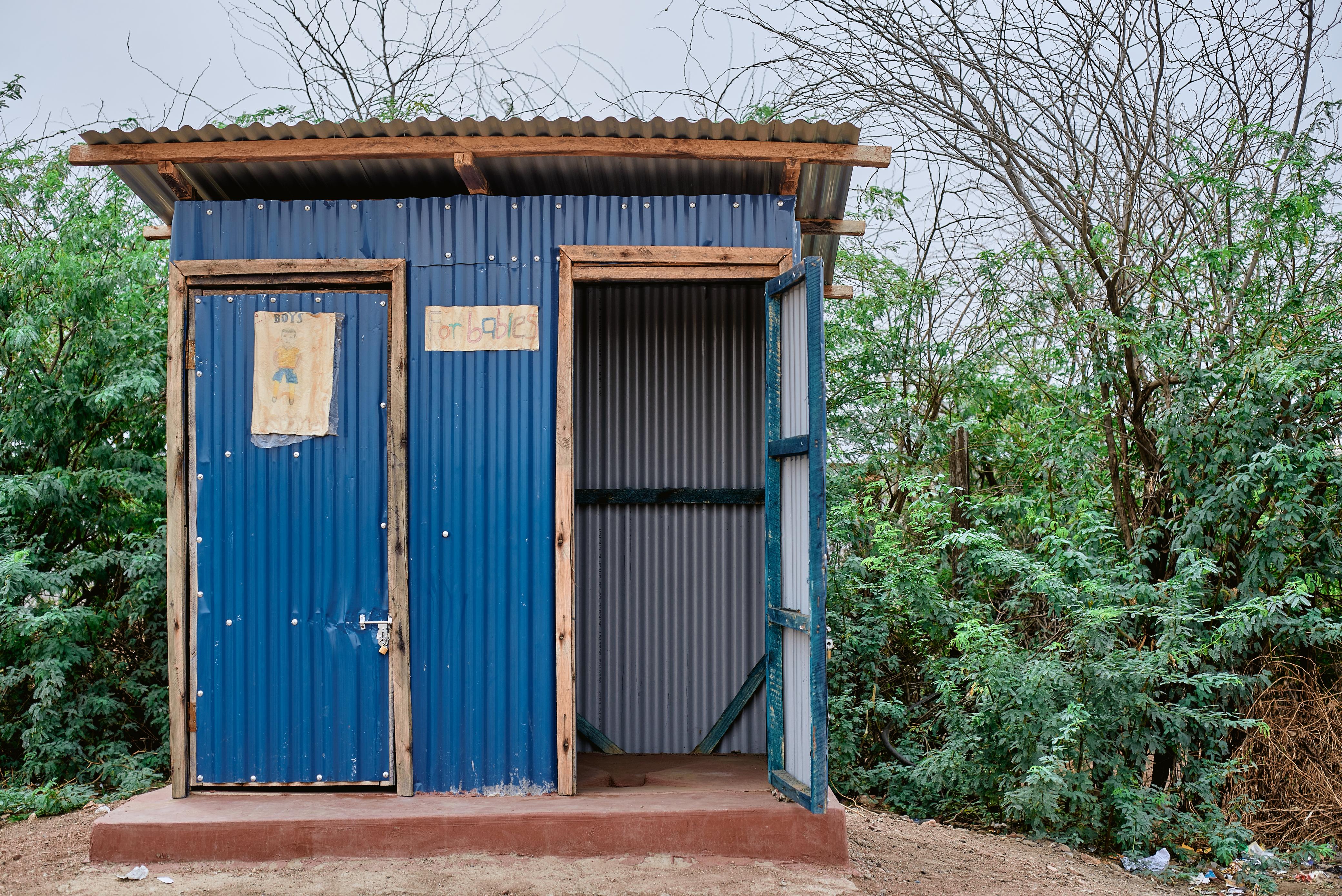 blue-metal-shed-children-toilet-bathroom-outdoors