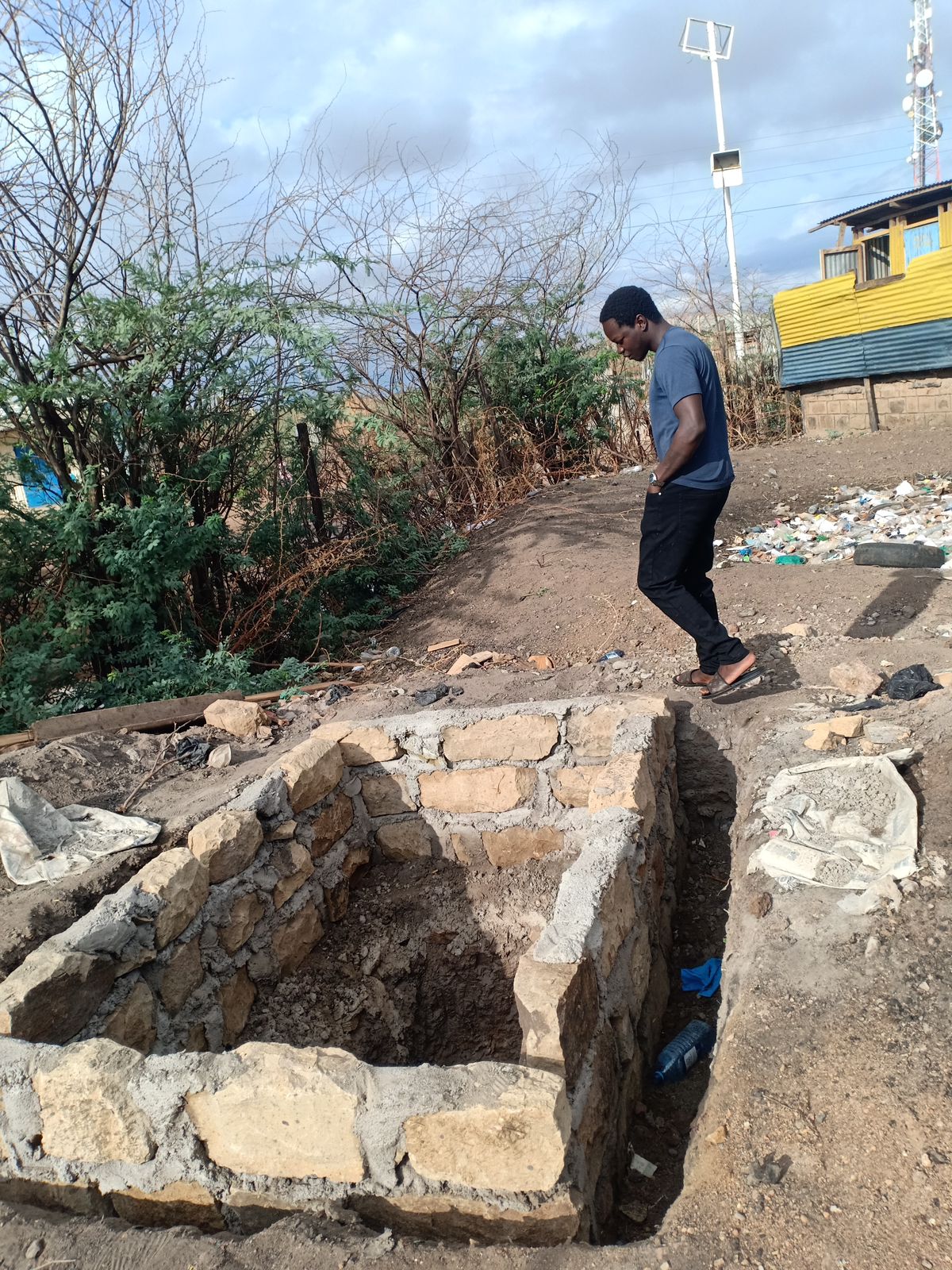 man-inspecting-stone-structure-in-wasteland.jpg