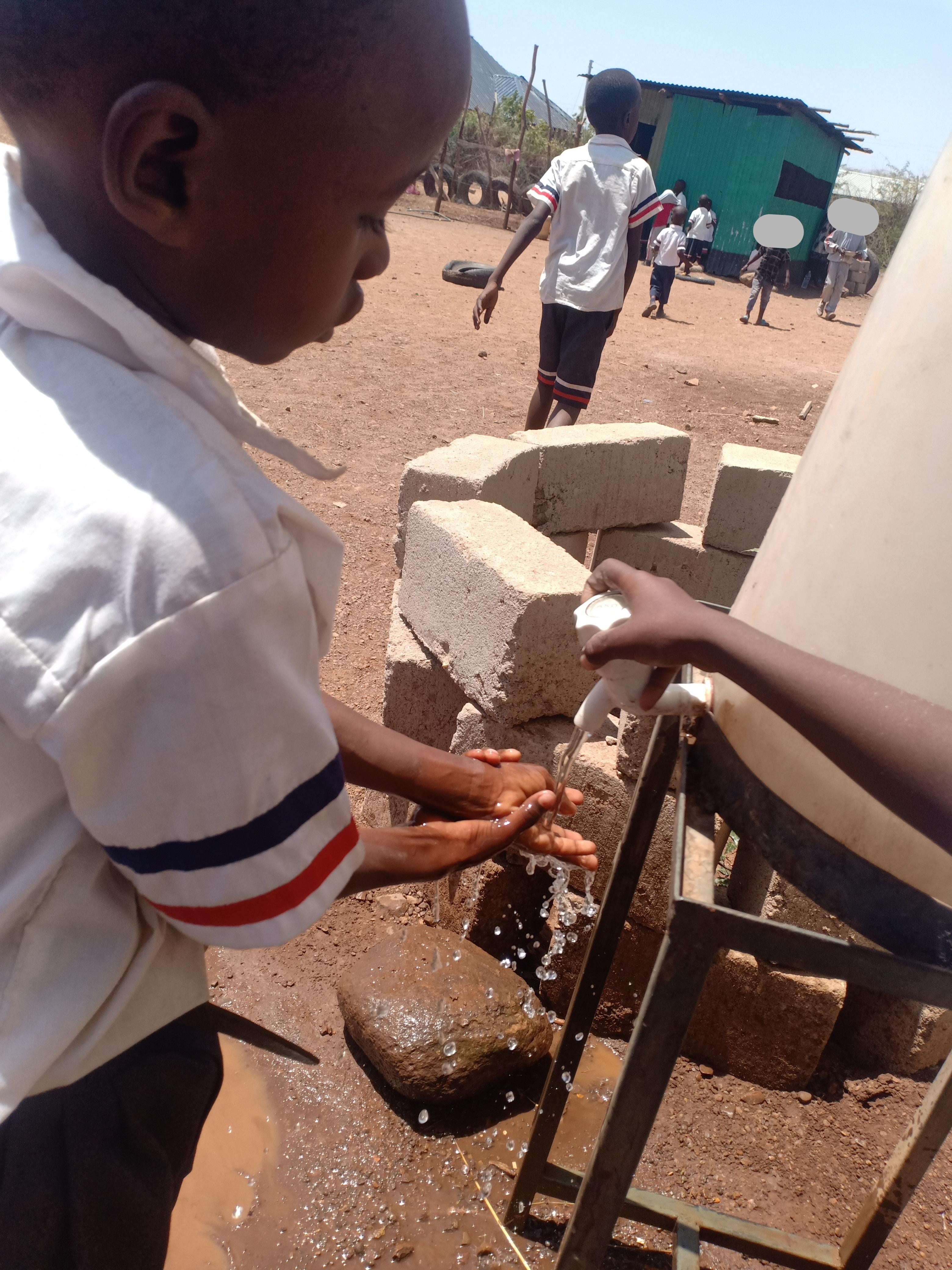 child-washing-hands-at-water-station.jpg